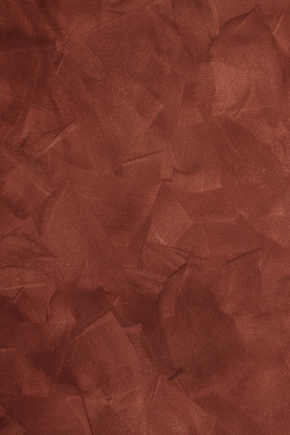 Finitura murale in intonaco veneziano ruvido color rosso mattone.